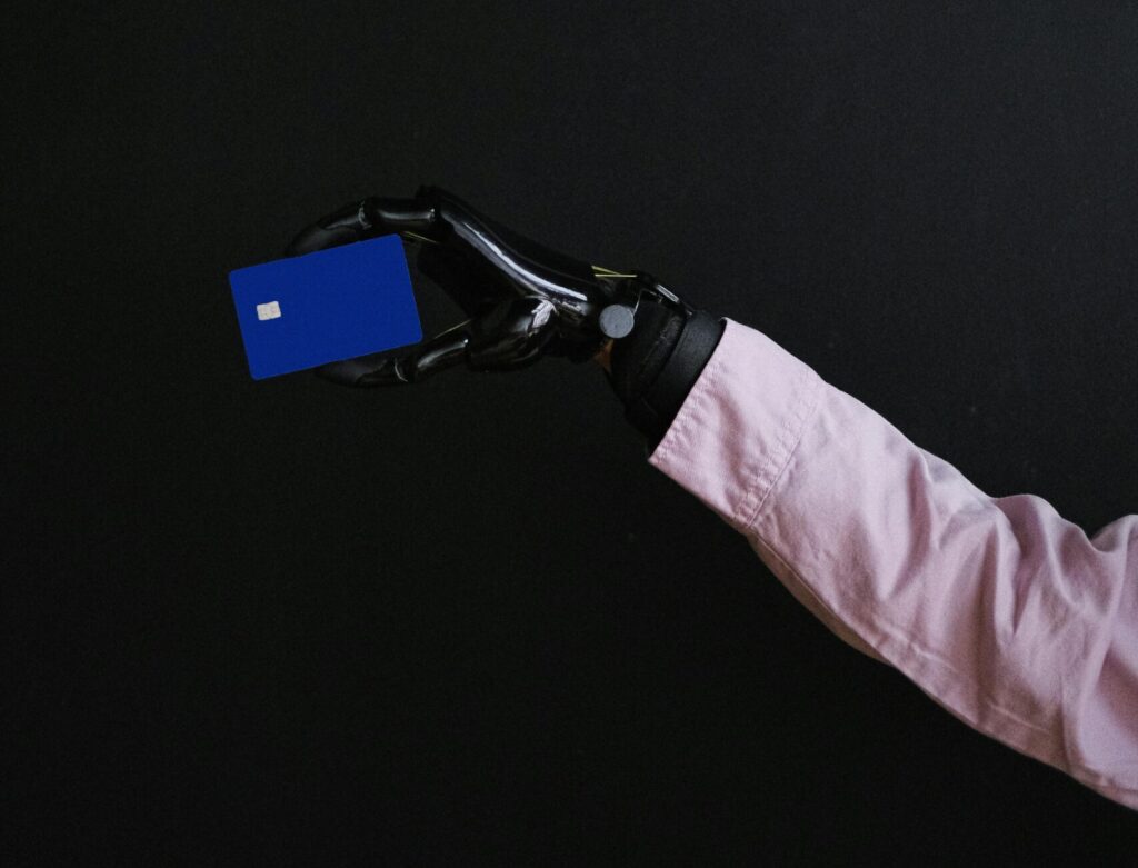 Robot hand holding credit card