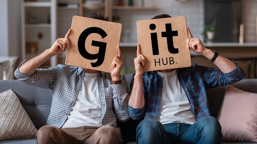 two men holding boards discussing Git hub